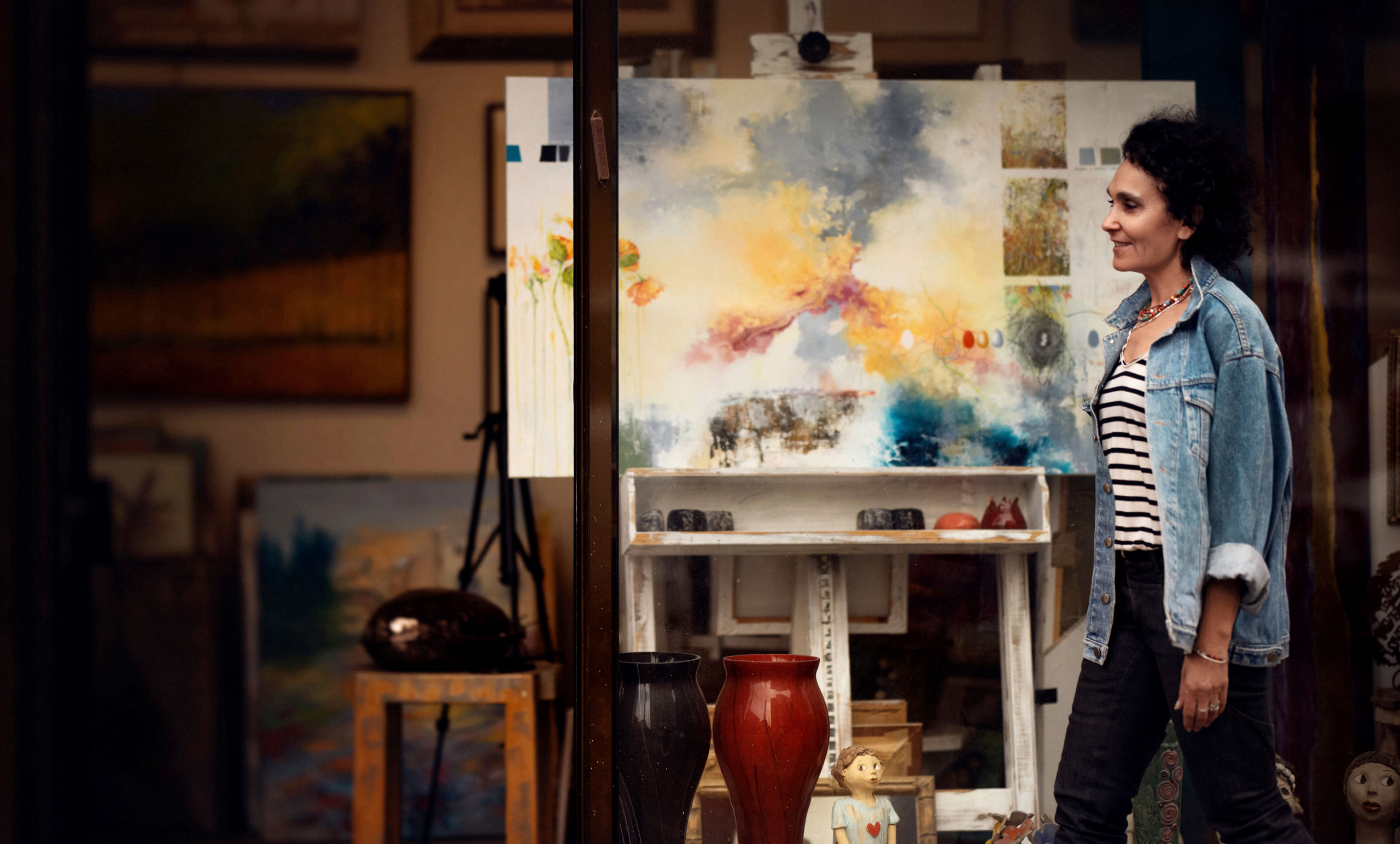 a person in front of a painting hamutal porat