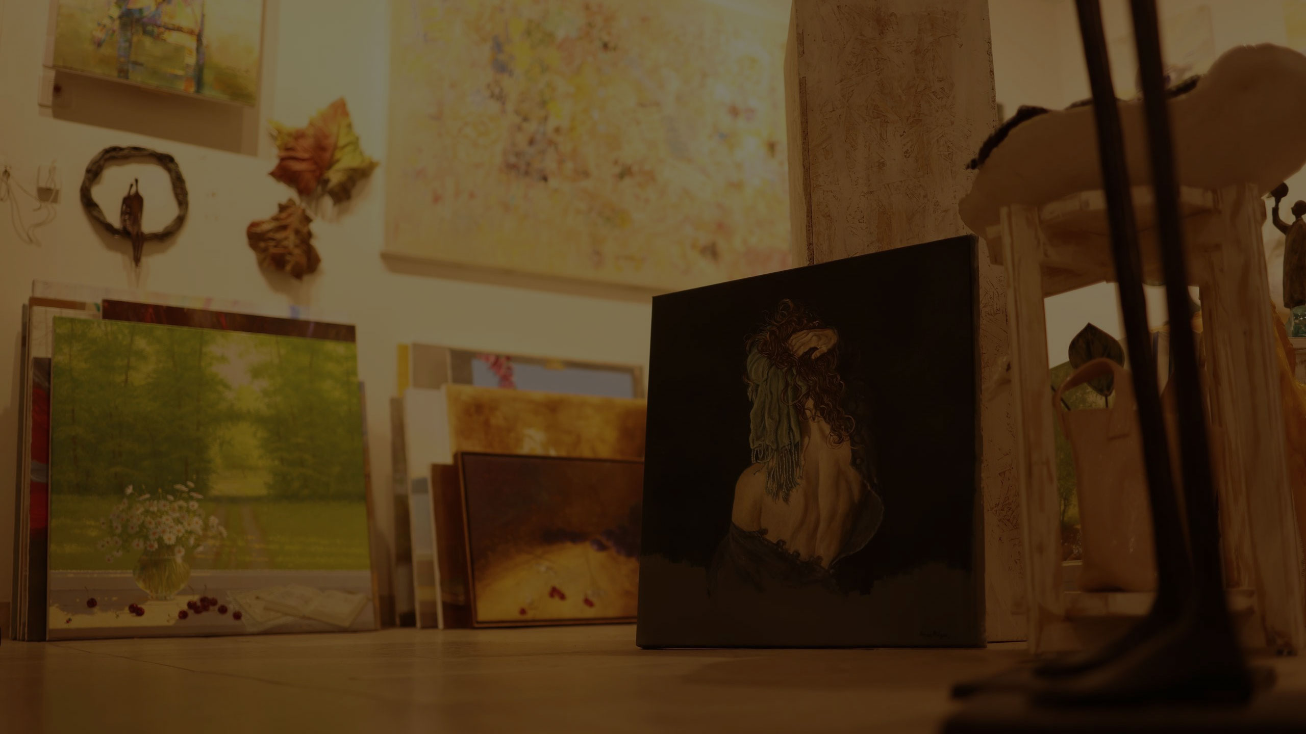 gallery with paintings on a wall and floor